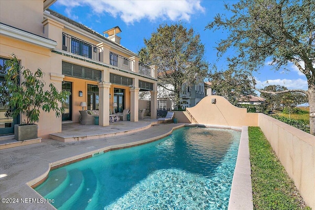 view of swimming pool featuring a fenced in pool, a fenced backyard, and a patio area