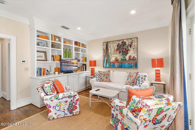 living area featuring crown molding, recessed lighting, wood finished floors, and baseboards