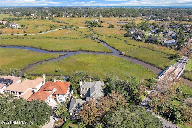 drone / aerial view featuring a residential view and a water view