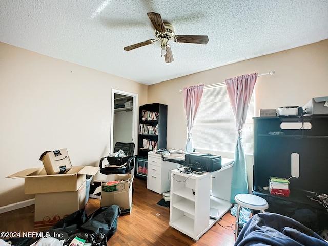 office featuring ceiling fan, wood-type flooring, and a textured ceiling