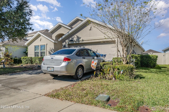 view of front facade with a front yard and a garage