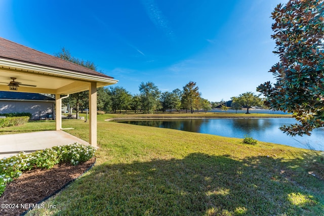 view of yard with a water view and a patio area