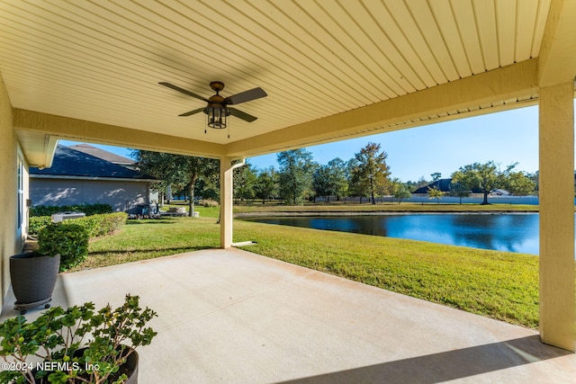 view of patio / terrace featuring ceiling fan and a water view