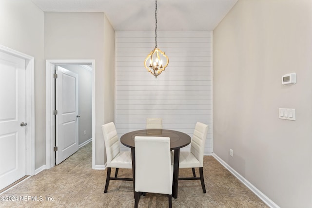 dining area with an inviting chandelier