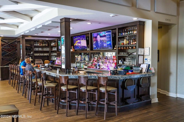 bar with hardwood / wood-style flooring