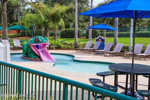 view of swimming pool featuring a patio area and a lawn