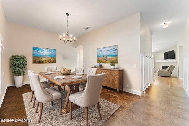 dining space with a notable chandelier and lofted ceiling