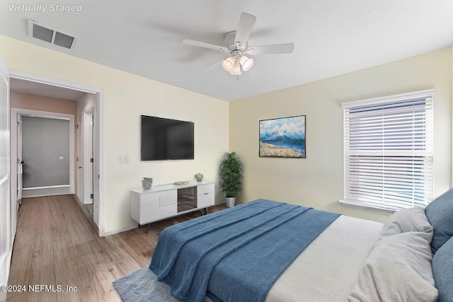 bedroom with ceiling fan and light wood-type flooring