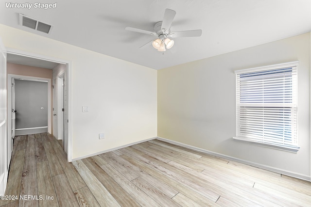 empty room featuring ceiling fan and light hardwood / wood-style floors