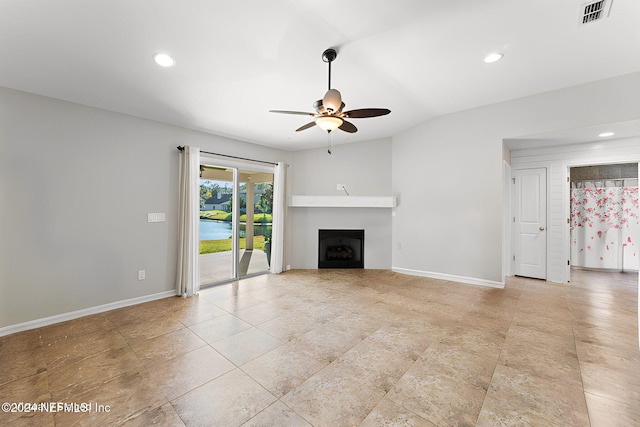 unfurnished living room featuring vaulted ceiling and ceiling fan