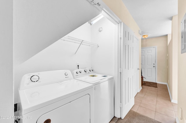 washroom with washer and clothes dryer and light tile patterned floors