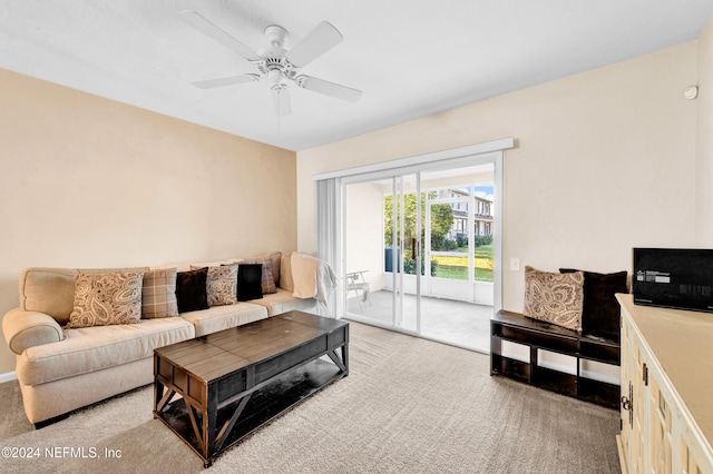 living room featuring ceiling fan and light colored carpet