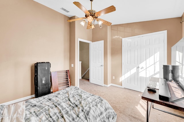 bedroom with light carpet, a closet, vaulted ceiling, and ceiling fan