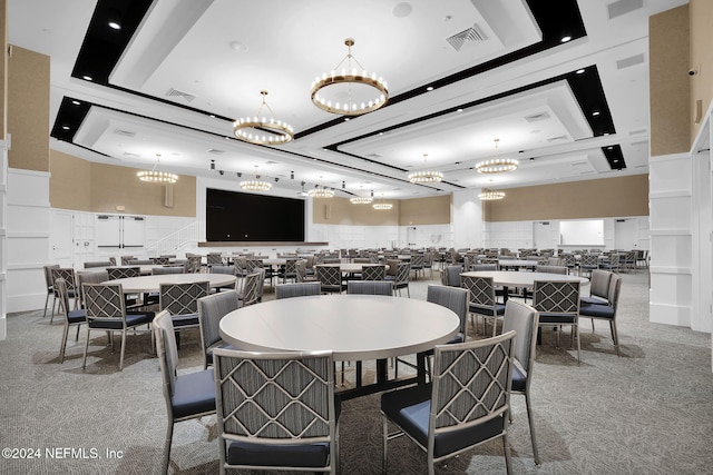 dining room featuring carpet flooring and a towering ceiling