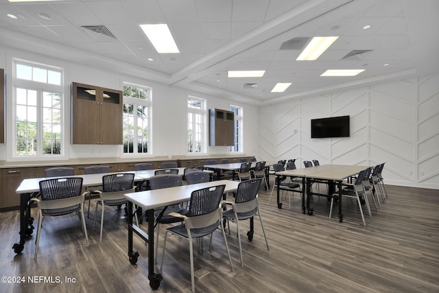 dining area featuring a paneled ceiling and dark wood-type flooring