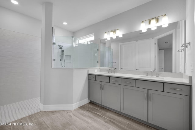 bathroom featuring vanity and tiled shower