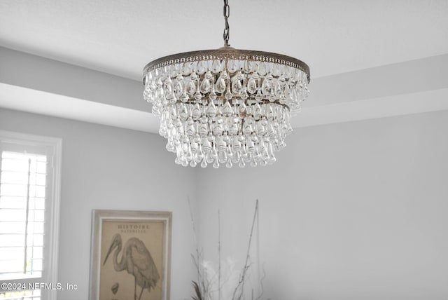 interior details featuring an inviting chandelier