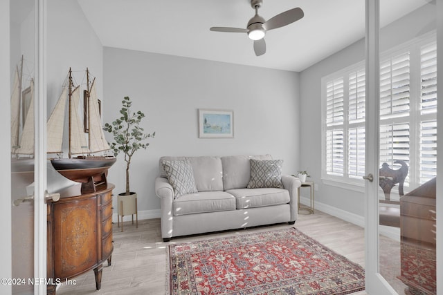 living room with french doors, light hardwood / wood-style floors, and ceiling fan