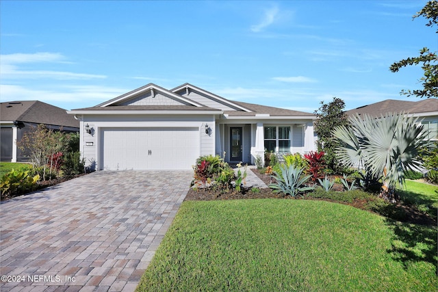 ranch-style home with a garage and a front yard