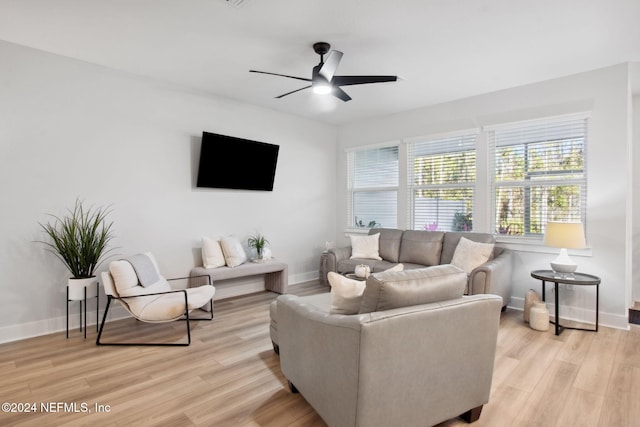 living room featuring light hardwood / wood-style floors and ceiling fan