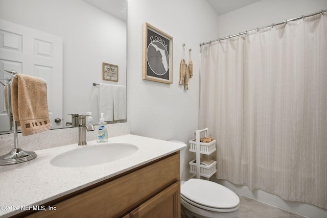 bathroom featuring curtained shower, tile patterned flooring, vanity, and toilet