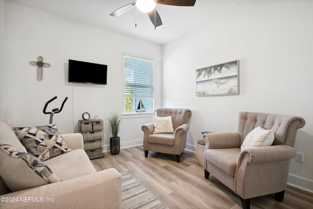 living room with light hardwood / wood-style floors and ceiling fan