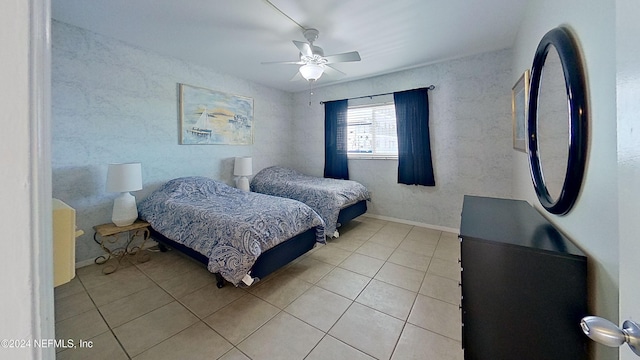 bedroom with ceiling fan and light tile patterned flooring