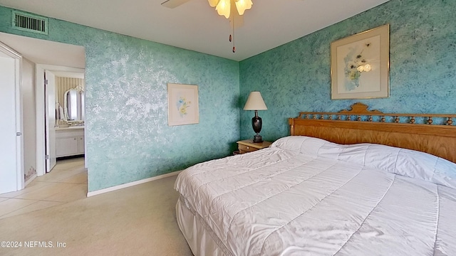 carpeted bedroom with connected bathroom and ceiling fan