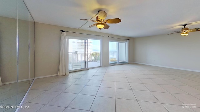 unfurnished room with ceiling fan and light tile patterned flooring