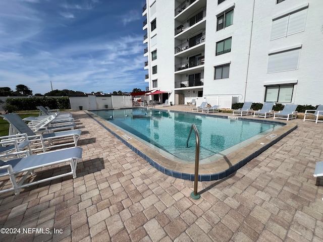 view of swimming pool featuring a patio