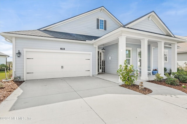 view of front of property with a porch and a garage