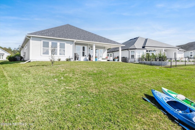 back of house featuring a patio area and a yard