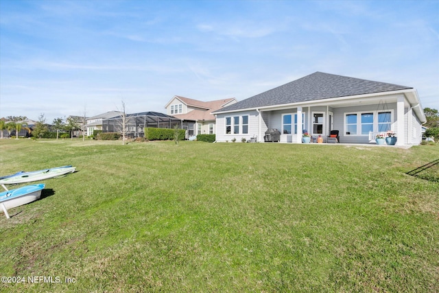 back of house featuring a yard