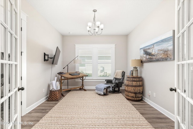 sitting room featuring dark hardwood / wood-style floors, french doors, and a chandelier