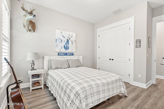 bedroom featuring a closet and hardwood / wood-style flooring