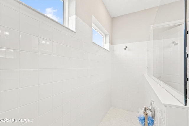 bathroom with a tile shower