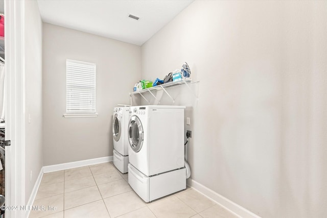 washroom with light tile patterned flooring and independent washer and dryer