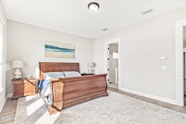 bedroom with hardwood / wood-style floors