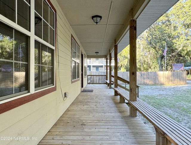 wooden terrace featuring covered porch