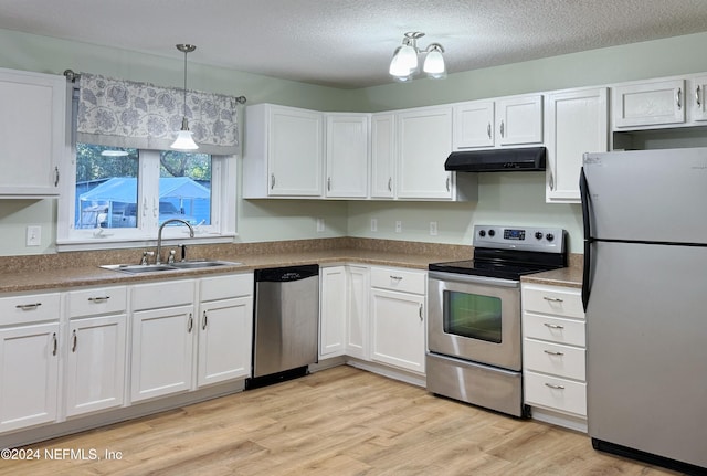 kitchen with white cabinetry, sink, stainless steel appliances, and light hardwood / wood-style floors