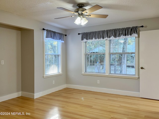 unfurnished room featuring ceiling fan, a textured ceiling, and hardwood / wood-style flooring