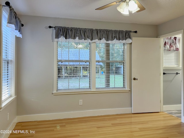 unfurnished room featuring ceiling fan, hardwood / wood-style floors, and a textured ceiling