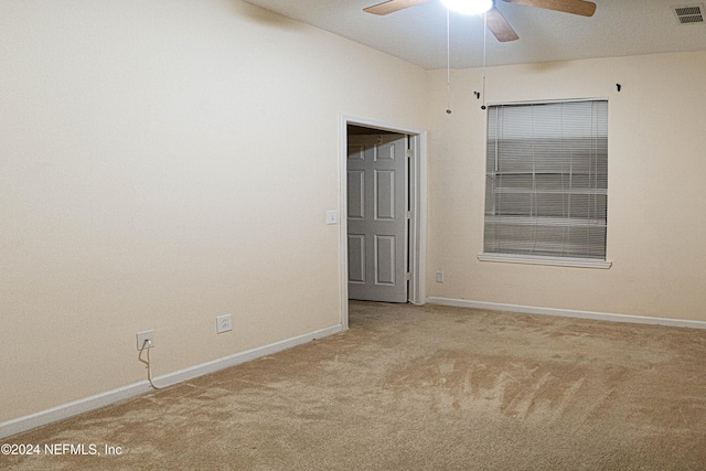 carpeted spare room with ceiling fan