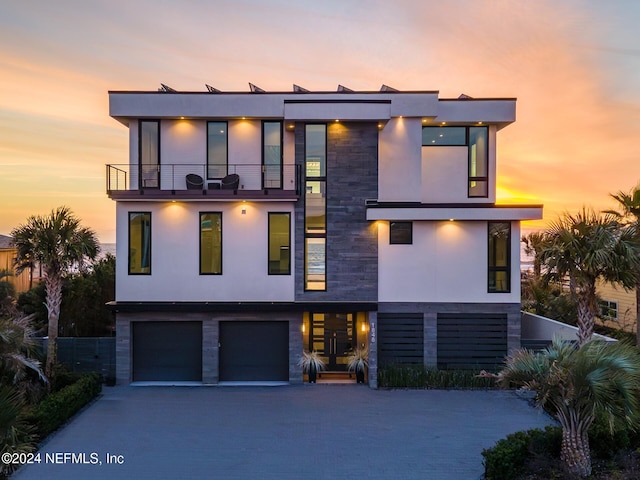 contemporary home featuring a balcony and a garage