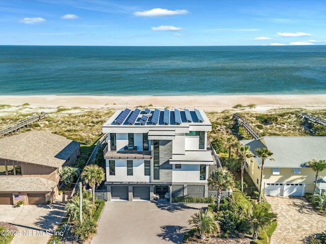 birds eye view of property featuring a beach view and a water view