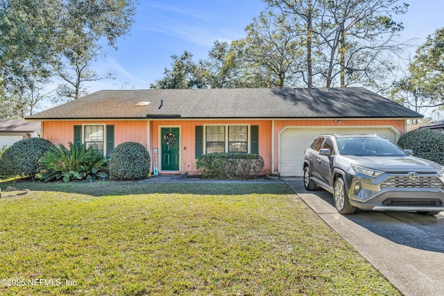 ranch-style house featuring a front lawn and a garage