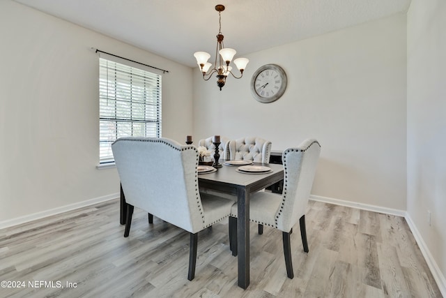 dining space featuring a chandelier and light hardwood / wood-style floors