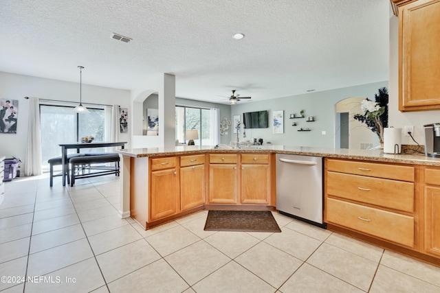 kitchen with ceiling fan, dishwasher, hanging light fixtures, kitchen peninsula, and light tile patterned flooring