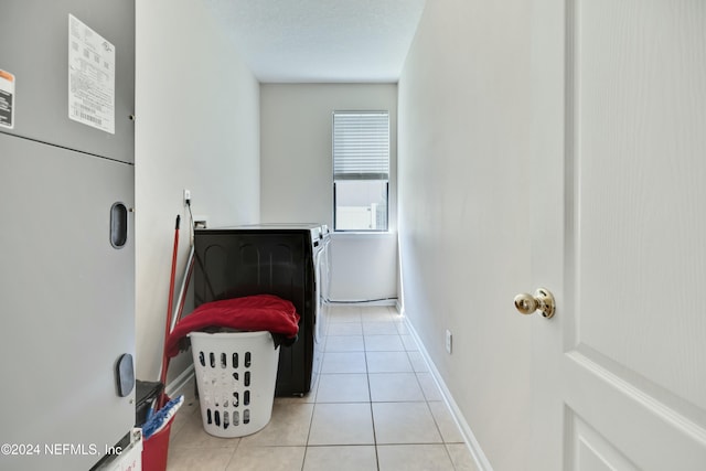 bedroom with light tile patterned flooring and a textured ceiling