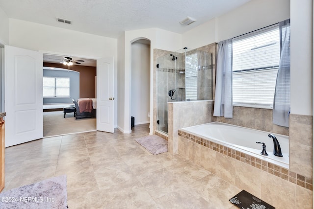 bathroom featuring plus walk in shower, a textured ceiling, tile patterned floors, and ceiling fan